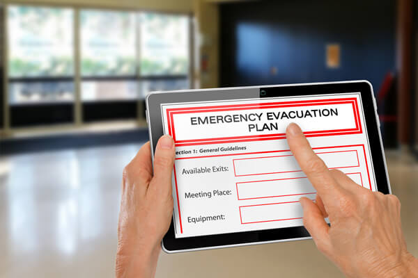 Photo of man holding an emergency evacuation plan