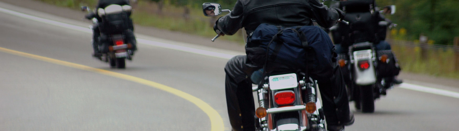 Close up photo of a motorcyclist driving from the back