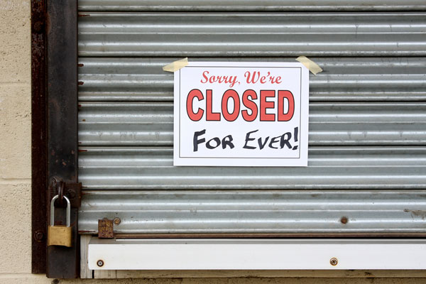 Locked storefront with a closed sign, preventable with Business Income coverage